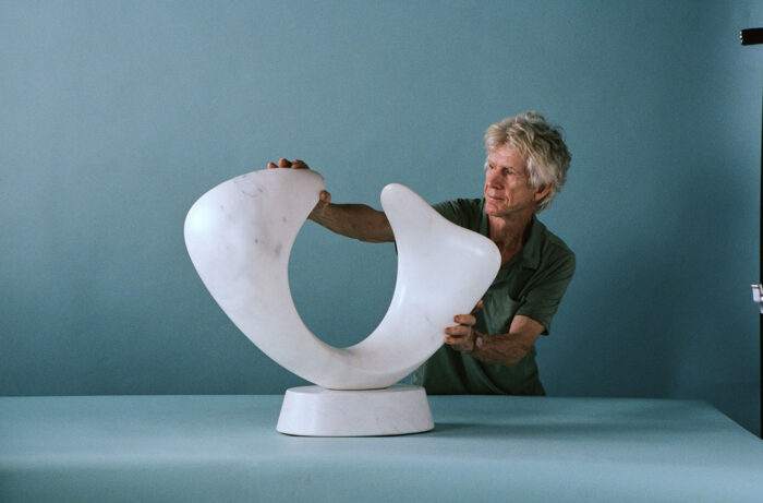 Sculptor Richard Erdman with Crescendo and abstract marble sculpture