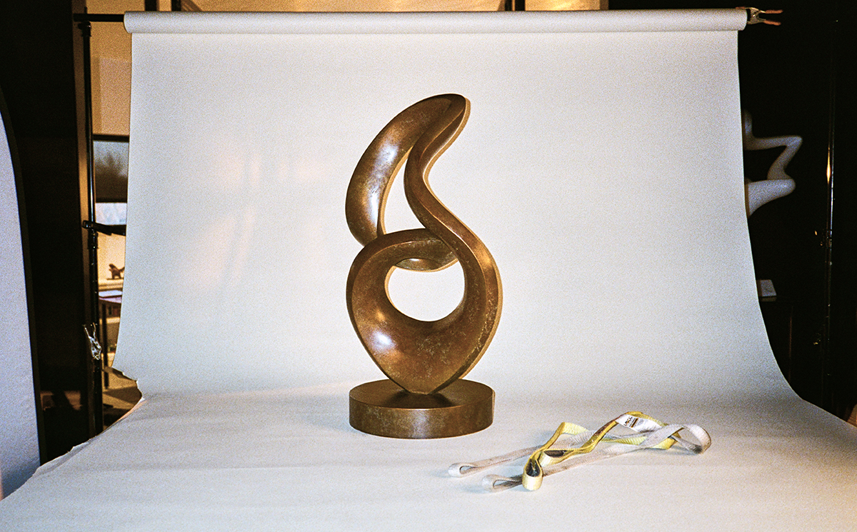 Abstract bronze sculpture installed for a photo shoot