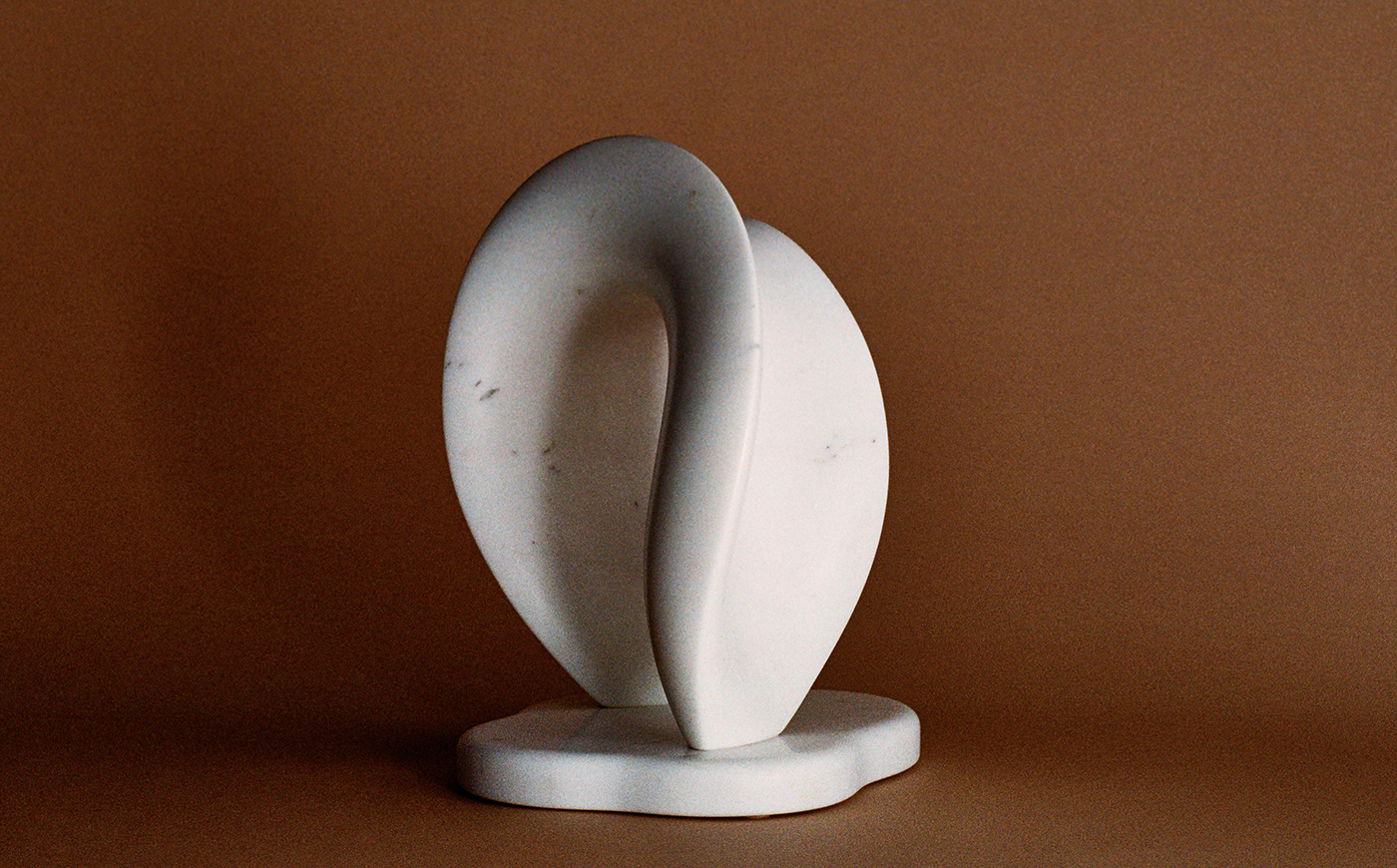 White Carrara Marble Sculpture, Hoku II, sits on a brown background
