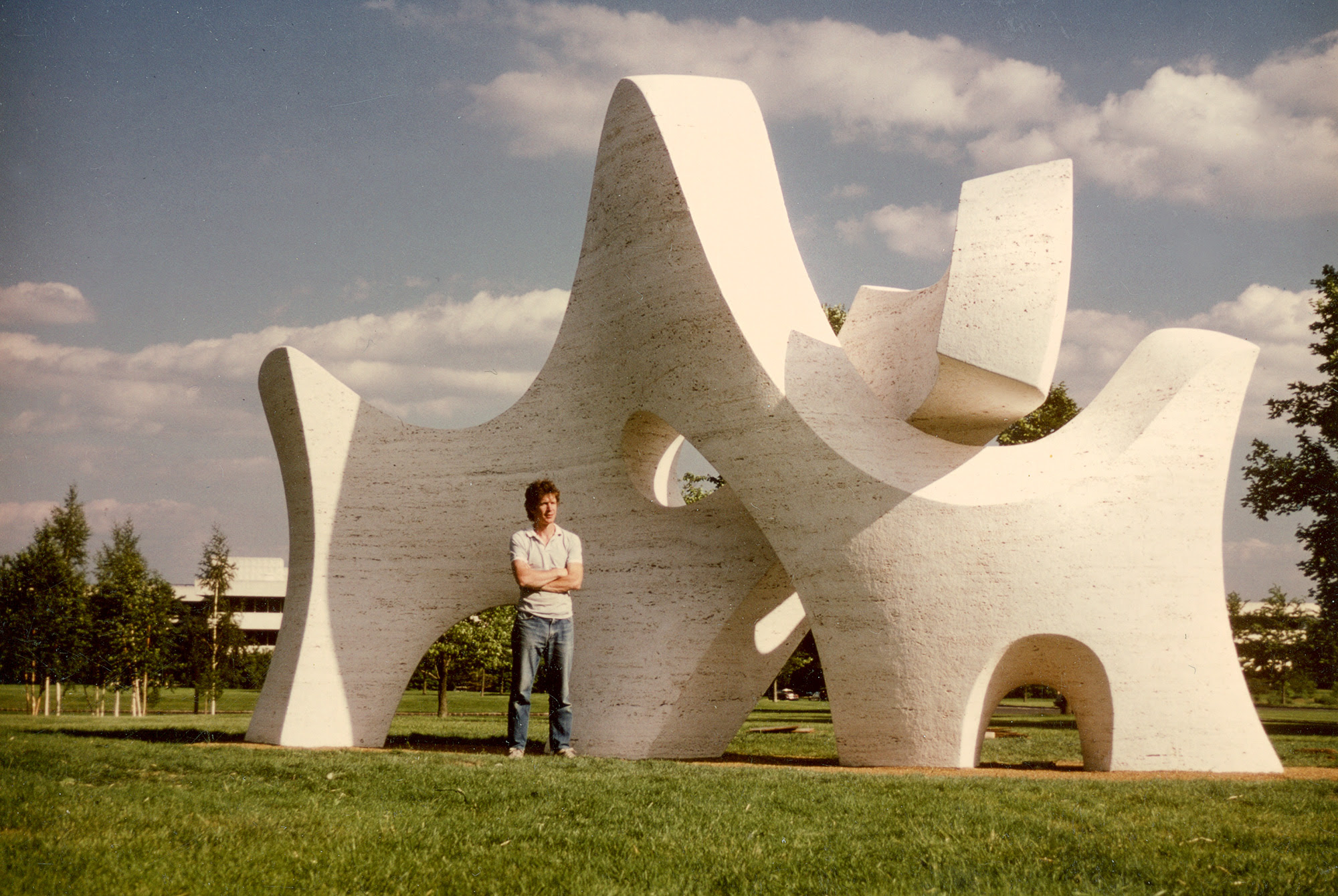 Sculptor Richard Erdman stands in front of the newly completed monumental sculpture, Passage at the Donald M. Kendall Sculpture Garden at Pepsi Co.
